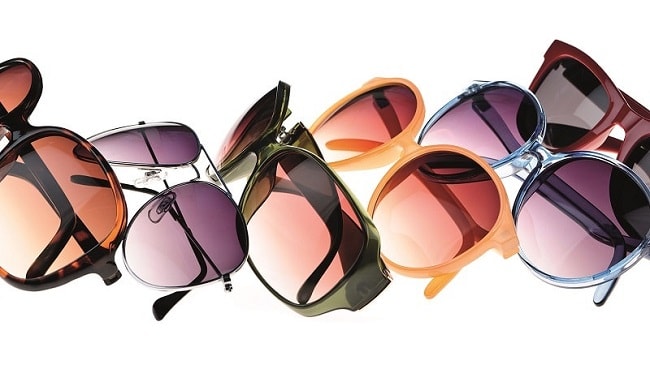 Mehrere bunte Sonnenbrillen auf weißem Hintergrund, Mode-Accessoire Sommer